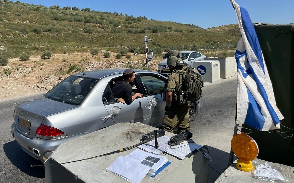 Yeshiva students at a checkpoint blocking the road to Homesh, May 26, 2022. (Carrie Keller-Lynn/The Times of Israel)