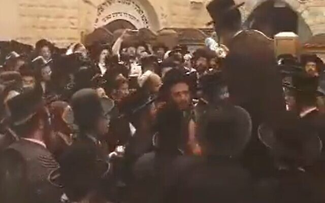 Haredi worshipers who broke into the Mount Meron compound celebrate in a courtyard on May 19, 2022 (video screenshot) Haredi worshipers who broke into the Mount Meron compound celebrate in a courtyard on May 19, 2022 (video screenshot)