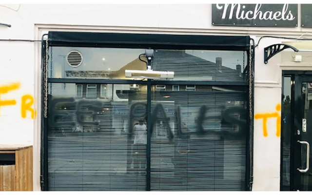 The words 'free Palestine' spray-painted on the facade of a cafe owned by an Israeli in London, May 14, 2022. (Michael Levi/JTA)