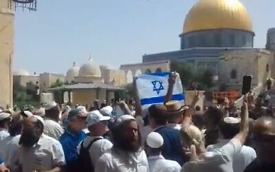 Jewish religious nationalists wave an Israeli flag on the Temple Mount, May 29, 2022. (Screen grab)