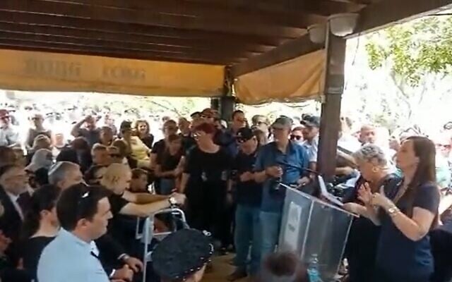 Mourners listen to the wife of former Meretz MK Ilan Gilon at the social activist's funeral in Kfar Saba, May 3, 2022 (Screen grab) Mourners listen to the wife of former Meretz MK Ilan Gilon at the social activist's funeral in Kfar Saba, May 3, 2022 (Screen grab)