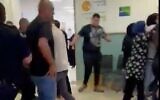 Family members and security guards clash at the Galilee Medical Center on May 18, 2022 (Screencapture/Channel 12)