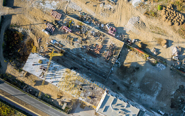 An aerial view of a construction site in Israel where a residential building is being built, October 2021. Illustrative. (photovs via iStock by Getty Images) An aerial view of a construction site in Israel where a residential building is being built, October 2021. Illustrative. (photovs via iStock by Getty Images)