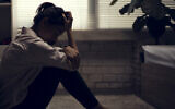 Illustrative: A young woman sits alone (torwai; iStock by Getty Images)