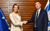 European Parliament President Roberta Metsola (left) shakes hands with Yisrael Beytenu MK Yossi Shain after arriving in Israel on May 22, 2022. (Courtesy)