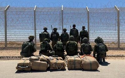 Troops stand next to drugs seized during a smuggling attempt on the Egypt border, on May 25, 2022. (Israel Defense Forces)