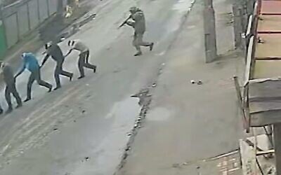 CCTV camera footage, obtained by The New York Times, shows Russian soldiers taking Ukrainian captives to their execution on March 4, 2022. (Screen grab)