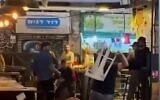People fighting at Jerusalem's Mahane Yehuda market with chairs and tables, May 15, 2022. (screenshot).