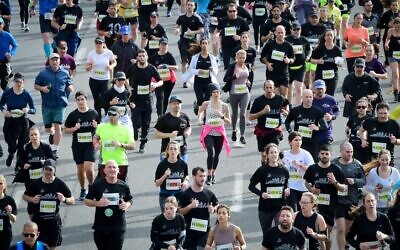 Runners take part in a marathon in Israel's coastal city of Tel Aviv on February 25, 2022. (Avshalom Sassoni/Flash90)