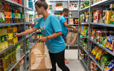 Wolt workers shop for customers at the Wolt Market grocery store in Neve Zedek, in Tel Aviv, May 2022. (Shai Azeri/Wolt Israel)