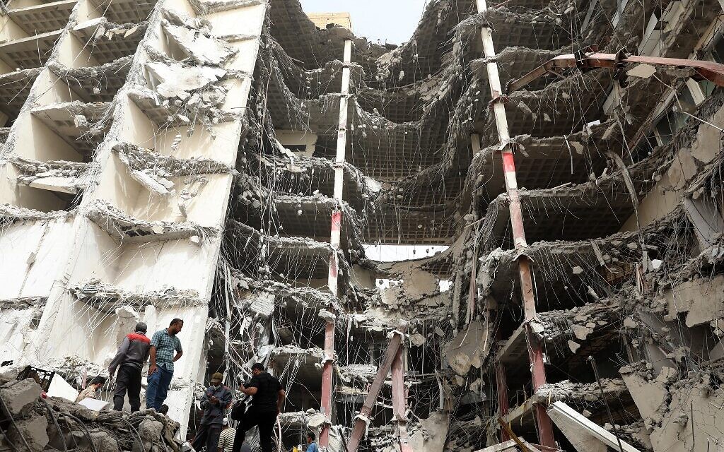 Iranians gather at the site where a ten-storey building collapsed as rescue operations continue in the southwestern city of Abadan on May 24, 2022. (TASNIM NEWS/AFP)