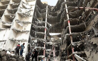 Iranians gather at the site where a ten-storey building collapsed as rescue operations continue in the southwestern city of Abadan on May 24, 2022. (TASNIM NEWS/AFP)