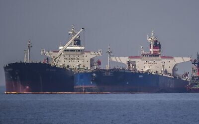 The Liberian-flagged oil tanker Ice Energy (L) transfers crude oil from the Russian-flagged oil tanker Lana (R) (former Pegas), off the shore of Karystos, on the Island of Evia, on May 29, 2022. (Angelos Tzortzinis/AFP)
