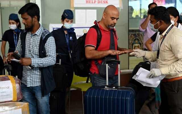 Health workers screen passengers arriving from abroad for monkeypox symptoms at Anna International Airport terminal in Chennai on June 03, 2022. (Arun Sankar/AFP) Health workers screen passengers arriving from abroad for monkeypox symptoms at Anna International Airport terminal in Chennai on June 03, 2022. (Arun Sankar/AFP)