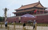 Policemen stand guard in front of the Tiananmen Gate during the 33rd anniversary of the June 4, 1989 crackdown on pro-democracy protests in Beijing, June 4, 2022. (Noel Celis/AFP)
