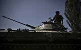 A Ukrainian soldier on top of an armoured vehicle moving towards the front line in the city of Lysychansk in the eastern Ukraine region of Donbas on June 9, 2022. (Aris Messinis / AFP)