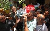 Mourners carry the body of Ali Harb, who was allegedly stabbed to death by an Israeli settler, during his funeral in the northern West Bank village of Iskaka on June 22, 2022. (JAAFAR ASHTIYEH / AFP)