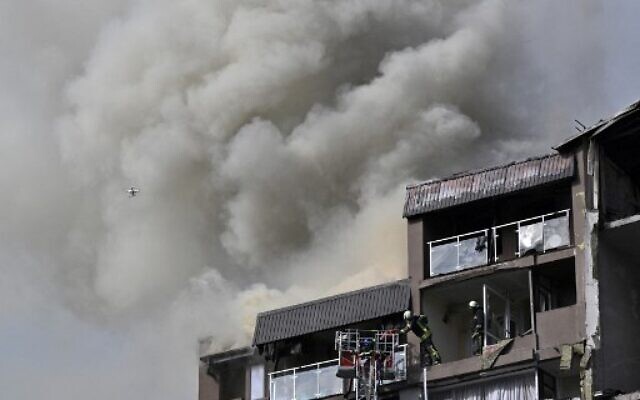 Rescuers and firefighters work in a damaged residential building, hit by Russian missiles in Kyiv on June 26, 2022, amid Russian invasion of Ukraine.(Genya SAVILOV / AFP)