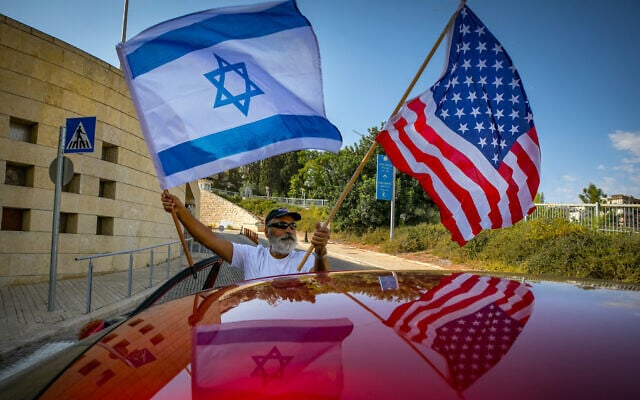 Israeli supporters of Donald Trump wave United States and Israeli flags to support his candidacy outside the US embassy in Jerusalem, on October 27, 2020. (Olivier Fitoussi/Flash90/File) Israeli supporters of Donald Trump wave United States and Israeli flags to support his candidacy outside the US embassy in Jerusalem, on October 27, 2020. (Olivier Fitoussi/Flash90/File)