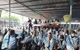 Illustrative: Men read from the Torah scroll during prayers at the synagogue in Gondar, Ethiopia, on May 31, 2022. (Amy Spiro/Times of Israel)