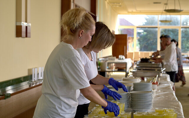 Women prepare kosher food for Jewish refugees from Ukraine in Balatonőszöd, Hungary, in June 2022. (Courtesy of EMIH)