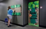 Illustrative: In this photo taken August 8, 2017, Megan Mitchum decorates the outside of a classroom in preparation for the start of the school year at the Mountain View Christian Schools in Las Vegas. (AP/John Locher)