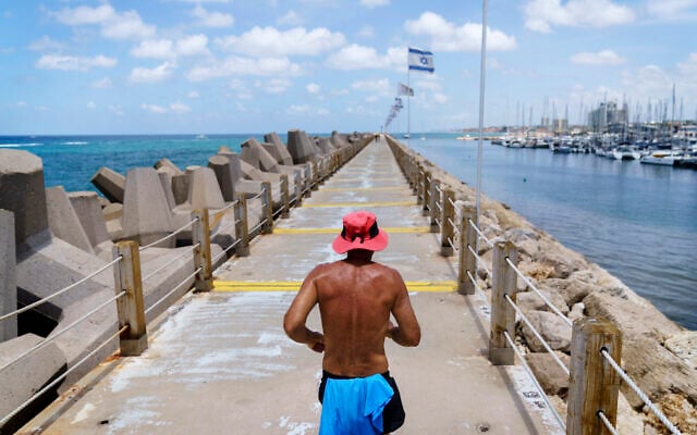 A jogger runs along a marina in Herzliya, Israel, June 2, 2021. (AP Photo/David Goldman) A jogger runs along a marina in Herzliya, Israel, June 2, 2021. (AP Photo/David Goldman)