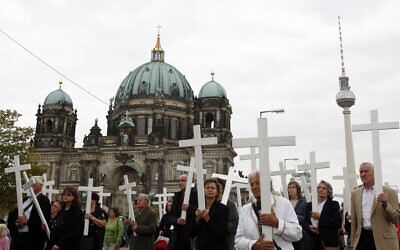 People carry crosses during a silent protest against abortion in front of the Berlin Cathedral in Berlin, September 26, 2009. (AP Photo/Franka Bruns, File)