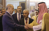 Turkish President Recep Tayyip Erdogan, left, and Saudi Arabia's Crown Prince Mohammed bin Salman speak after their meeting in Jiddah, Saudi Arabia, early Friday, April 29, 2022. Prince Mohammed is due to visit Turkey next week. (Turkish Presidency via AP)