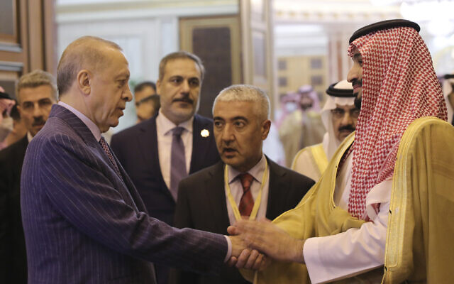 Turkish President Recep Tayyip Erdogan, left, and Saudi Arabia's Crown Prince Mohammed bin Salman speak after their meeting in Jiddah, Saudi Arabia, early Friday, April 29, 2022. Prince Mohammed is due to visit Turkey next week. (Turkish Presidency via AP)