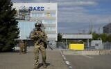 A Russian serviceman stands guard in an area of the Zaporizhzhia Nuclear Power Station in territory under Russian military control, southeastern Ukraine, May 1, 2022. (AP Photo)