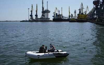 Servicemen of Donetsk People's Republic Emergency Ministry work to defuse a Ukrainian mine in an area of the Mariupol Sea Port in Mariupol, in territory under the government of the Donetsk People's Republic, eastern Ukraine, on April 29, 2022. This photo was taken during a trip organized by the Russian Ministry of Defense. (AP)