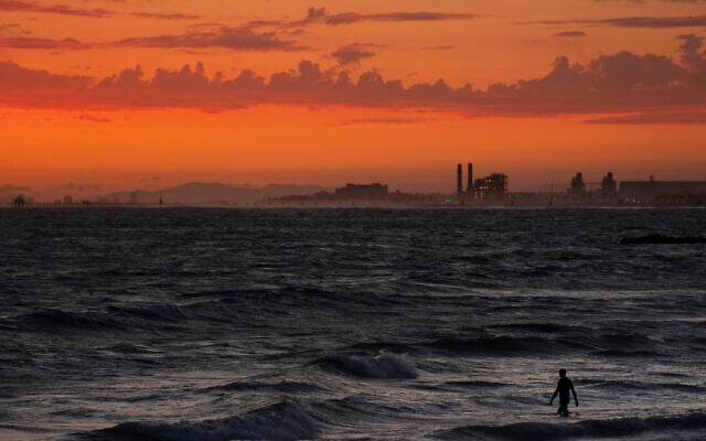 A man wades into the ocean at sunset on June 22, 2021, in Newport Beach, California. (Jae C. Hong/AP) A man wades into the ocean at sunset on June 22, 2021, in Newport Beach, California. (Jae C. Hong/AP)