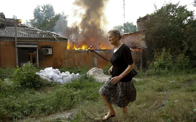 A woman runs from a house that's on fire after shelling in Donetsk, on the territory which is under the Government of the Donetsk People's Republic control, eastern Ukraine, June 3, 2022. (AP Photo/Alexei Alexandrov) A woman runs from a house that's on fire after shelling in Donetsk, on the territory which is under the Government of the Donetsk People's Republic control, eastern Ukraine, June 3, 2022. (AP Photo/Alexei Alexandrov)