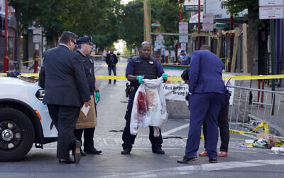 Philadelphia Police investigators work the scene of a fatal overnight shooting on South Street in Philadelphia, Sunday, June 5, 2022. (AP Photo/Michael Perez)