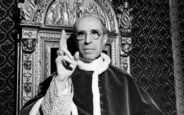 Pope Pius XII, wearing the ring of St. Peter, raises his right hand in a papal blessing at the Vatican, in Sept. 1945. (AP Photo) Pope Pius XII, wearing the ring of St. Peter, raises his right hand in a papal blessing at the Vatican, in Sept. 1945. (AP Photo)