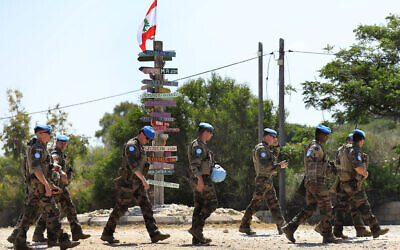 French U.N. peacekeepers walk on a road that leads to a United Nations Interim Force In Lebanon position, in the southern coastal border Lebanese-Israeli town of Naqoura, Lebanon, Monday, June 6, 2022. The Lebanese government invited on Monday a U.S. envoy mediating between Lebanon and Israel over their disputed maritime border to return to Beirut as soon as possible to work out an agreement amid rising tensions along the border. (AP Photo/Mohammed Zaatari)