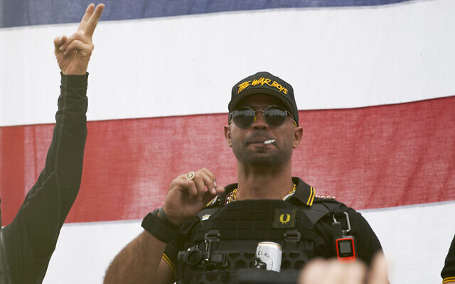 Proud Boys leader Enrique Tarrio wears a hat that says The War Boys and smokes a cigarette at a rally in Delta Park on Sept. 26, 2020, in Portland, Ore. Tarrio, the former top leader of the far-right Proud Boys extremist group, and other members were indicted Monday, June 6, 2022, on seditious conspiracy charges for what federal prosecutors say was a coordinated attack on the U.S. Capitol to stop Congress from certifying President Joe Biden's 2020 electoral victory.(AP Photo/Allison Dinner, File) Proud Boys leader Enrique Tarrio wears a hat that says The War Boys and smokes a cigarette at a rally in Delta Park on Sept. 26, 2020, in Portland, Ore. Tarrio, the former top leader of the far-right Proud Boys extremist group, and other members were indicted Monday, June 6, 2022, on seditious conspiracy charges for what federal prosecutors say was a coordinated attack on the U.S. Capitol to stop Congress from certifying President Joe Biden's 2020 electoral victory.(AP Photo/Allison Dinner, File)