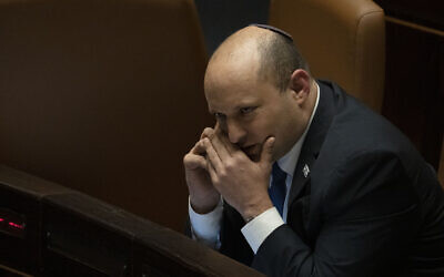 Prime Minister Naftali Bennett makes a call before voting on a law on the legal status of Israelis in the West Bank, during a session of the Knesset, Monday, June 6, 2022. (AP Photo/ Maya Alleruzzo) Prime Minister Naftali Bennett makes a call before voting on a law on the legal status of Israelis in the West Bank, during a session of the Knesset, Monday, June 6, 2022. (AP Photo/ Maya Alleruzzo)