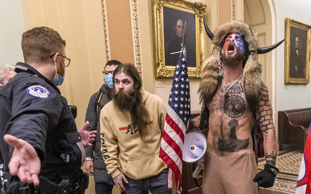Supporters of President Donald Trump, including Jacob Chansley, right with fur hat, are confronted by US Capitol Police officers outside the Senate Chamber inside the Capitol in Washington, Jan. 6, 2021. (Manuel Balce Ceneta/AP) Supporters of President Donald Trump, including Jacob Chansley, right with fur hat, are confronted by US Capitol Police officers outside the Senate Chamber inside the Capitol in Washington, Jan. 6, 2021. (Manuel Balce Ceneta/AP)