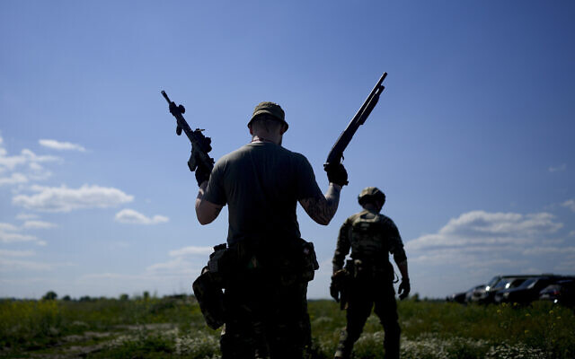 A civilian militia man holds a shotgun and a rifle during training at a shooting range in outskirts Kyiv, Ukraine, June 7, 2022. (Natacha Pisarenko/AP) A civilian militia man holds a shotgun and a rifle during training at a shooting range in outskirts Kyiv, Ukraine, June 7, 2022. (Natacha Pisarenko/AP)