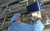 An inspector of the International Atomic Energy Agency sets up surveillance equipment, at the Uranium Conversion Facility of Iran, just outside the city of Isfahan, Iran, Aug. 8, 2005  (AP Photo/Mehdi Ghasemi, ISNA, File )