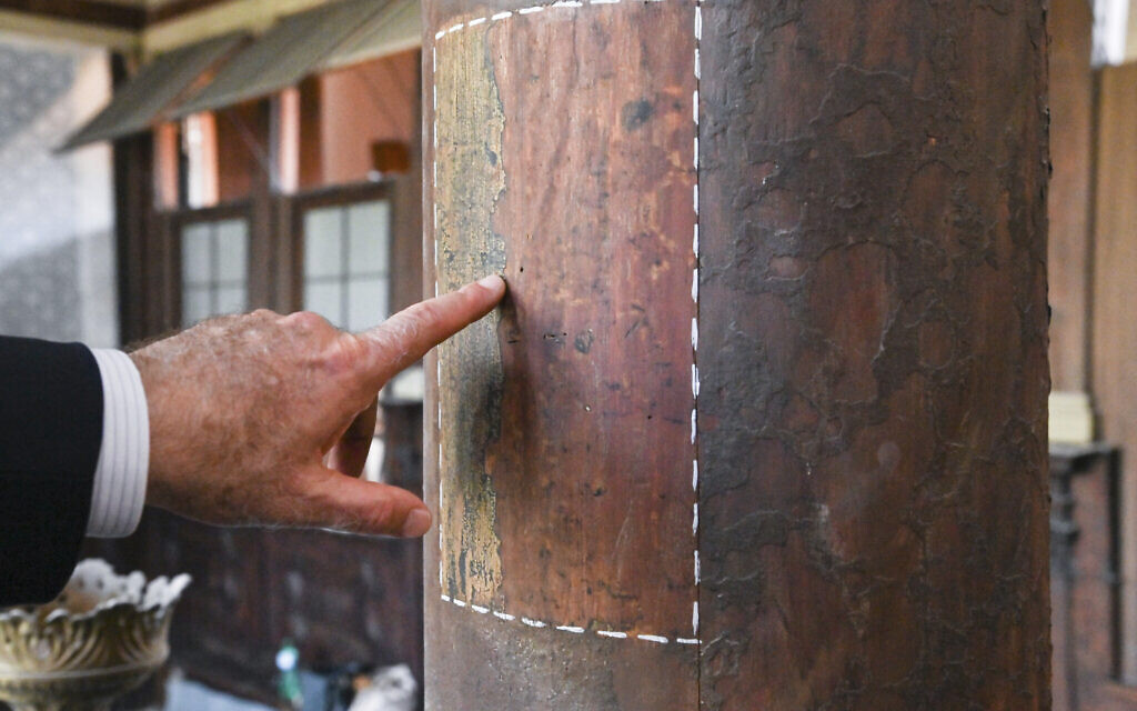 Art historian David Landau points out a restored area of a wooden column in the 1575 Italian Schola Synagogue in Venice, northern Italy, June 1, 2022. Landau is spearheading the fundraising effort to restore Venice's synagogues and nearby buildings both for Venice’s small Jewish community and for tourists who can visit them on a guided tour through the Jewish Museum of Venice. (AP Photo/Chris Warde-Jones)