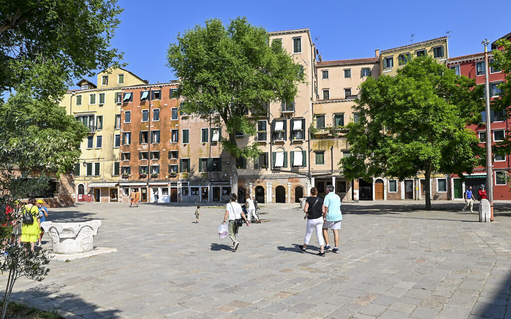 People walk in the Campo del Ghetto Nuovo (New Ghetto Grounds) in Venice, northern Italy, June 1, 2022. Venice’s Jewish ghetto is considered the first in Europe and one of the first in the world, and a new effort is underway to preserve its 16th century synagogues for the Jews who have remained and tourists who pass through. (AP Photo/Chris Warde-Jones)