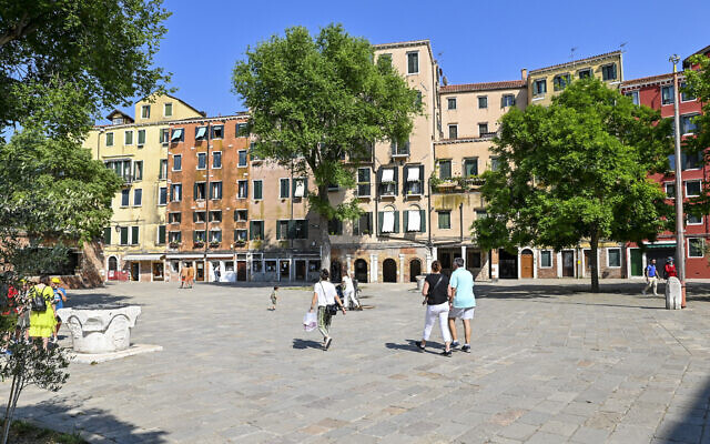 People walk in the Campo del Ghetto Nuovo (New Ghetto Grounds) in Venice, northern Italy, June 1, 2022. Venice’s Jewish ghetto is considered the first in Europe and one of the first in the world, and a new effort is underway to preserve its 16th century synagogues for the Jews who have remained and tourists who pass through. (AP Photo/Chris Warde-Jones)