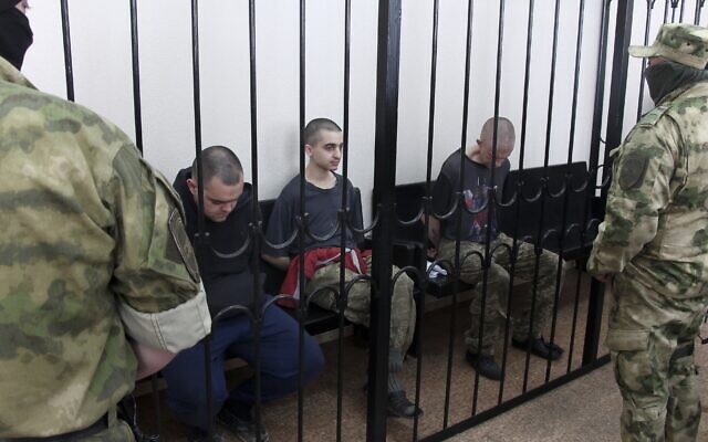 Two British citizens Aiden Aslin, left, and Shaun Pinner, right, and Moroccan Saaudun Brahim, center, sit behind bars in a courtroom in Donetsk, in the territory which is under the Government of the Donetsk People's Republic control, eastern Ukraine, Thursday, June 9, 2022. (AP Photo) Two British citizens Aiden Aslin, left, and Shaun Pinner, right, and Moroccan Saaudun Brahim, center, sit behind bars in a courtroom in Donetsk, in the territory which is under the Government of the Donetsk People's Republic control, eastern Ukraine, Thursday, June 9, 2022. (AP Photo)