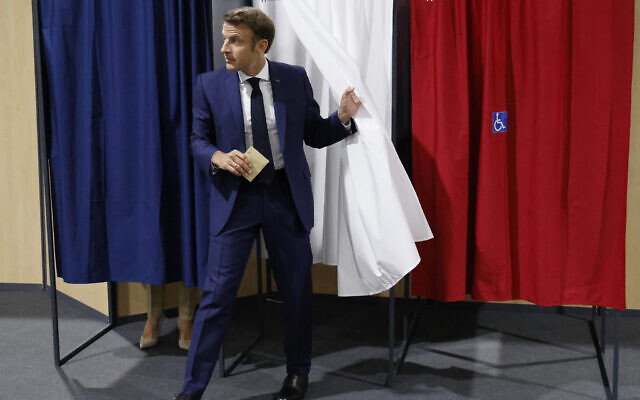France's President Emmanuel Macron leaves the voting booth after voting in the first round of French parliamentary election at a polling station in Le Touquet, northern France, June 12, 2022. (Ludovic Marin, Pool via AP) France's President Emmanuel Macron leaves the voting booth after voting in the first round of French parliamentary election at a polling station in Le Touquet, northern France, June 12, 2022. (Ludovic Marin, Pool via AP)