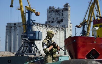 A Russian soldier guards a pier with the grain storage in the background at an area of the Mariupol Sea Port which has recently started its work after heavy fighting in Mariupol, on the territory which is under the Government of the Donetsk People's Republic control, eastern Ukraine, June 12, 2022. This photo was taken during a trip organized by the Russian Ministry of Defense. (AP Photo)