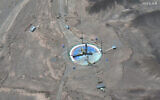 This satellite image from Maxar Technologies shows a rocket preparing to be erected at a launch pad at Imam Khomeini Space Center southeast of Semnan, Iran, on Tuesday, June 14, 2022. (Satellite image ©2022 Maxar Technologies via AP)