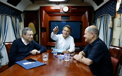 French President Emmanuel Macron, center, German Chancellor Olaf Scholz, right, and Italian Prime Minister Mario Draghi travel on board a train bound to Kyiv after departing from Poland, June 16, 2022 (Ludovic Marin, Pool via AP)